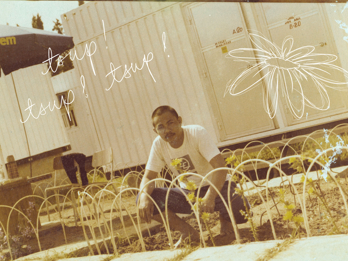 A Filipino man squats to pose with flowers in a garden in Skikda, Algeria, in the springtime of 1978. A doodle animation makes a flower and spells "tsup! tsup! tsup!"